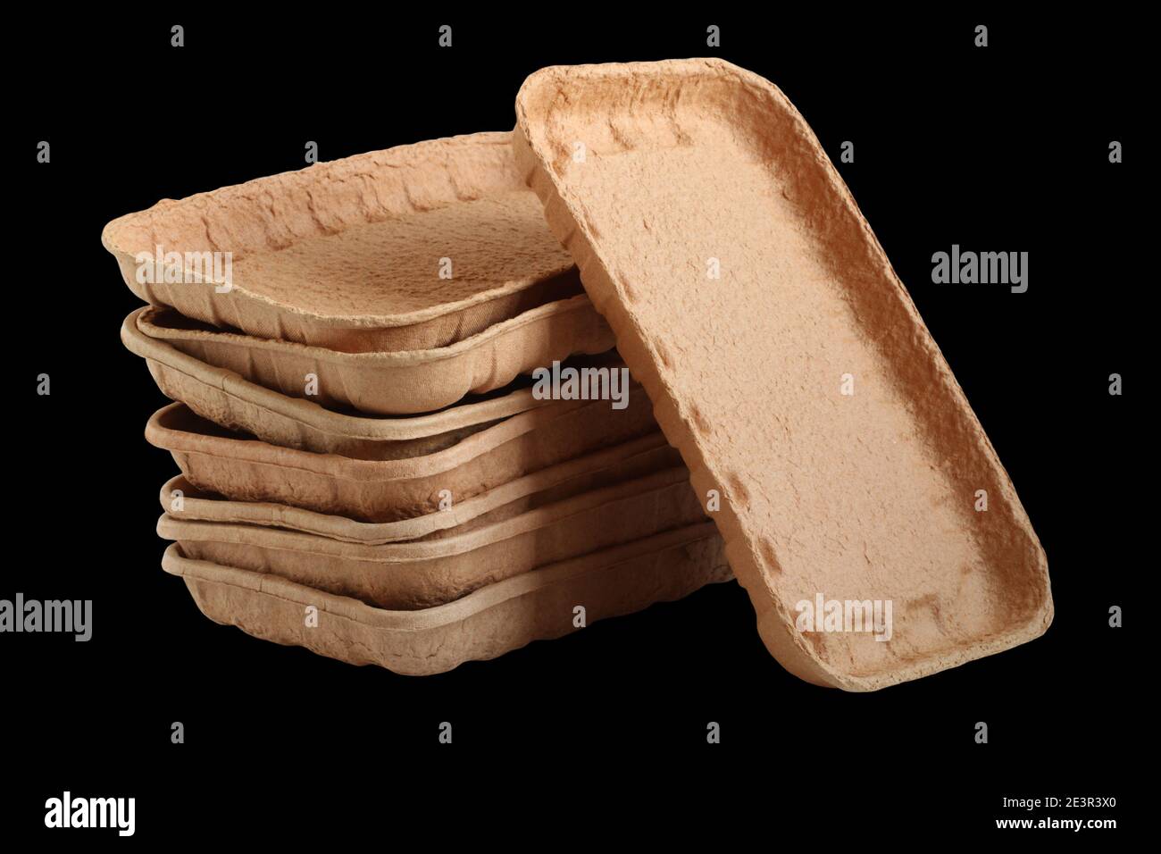 Biodegradable food trays made from pressed cardboard isolated on black