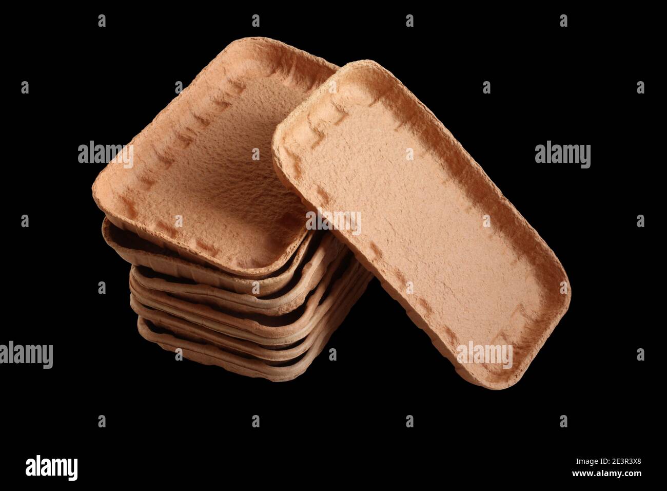 Biodegradable food trays made from pressed cardboard isolated on black background. Closeup Stock Photo