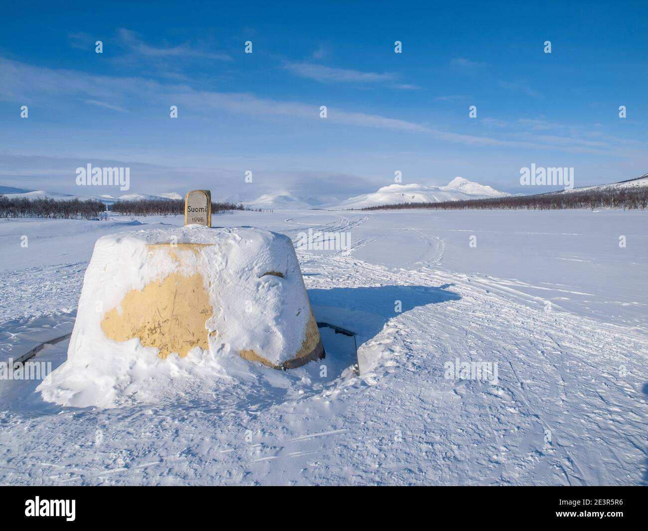 The Three Border Stone / Cairn marking the border between Finland, Norway and Sweden near Kilpisjarvi,  in winter Stock Photo