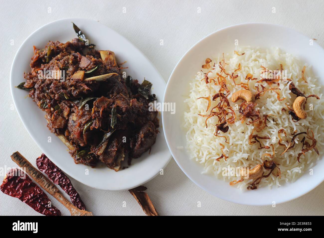 Aromatic traditional Ghee rice and spicy mutton roast prepared in Kerala style for special occasions like Christmas, Easter, Onam and other festivals Stock Photo