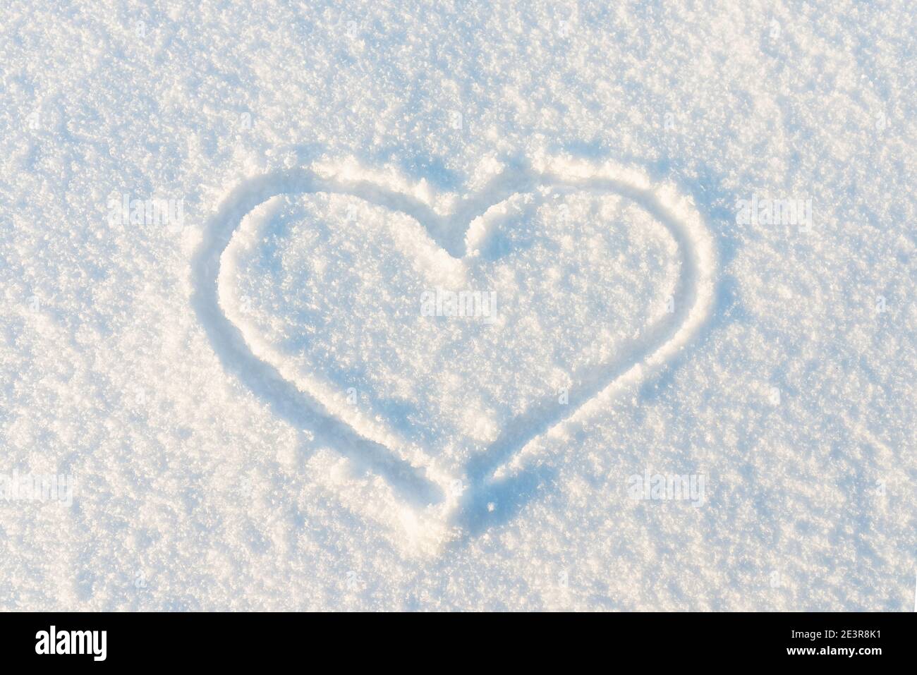 Drawn Heart shape on the snow.Top view image Stock Photo - Alamy