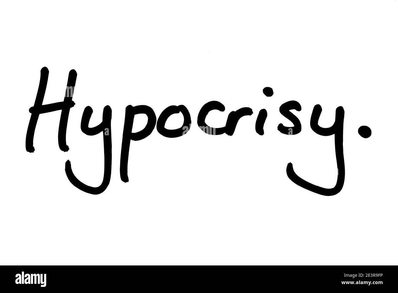 Hypocrisy, handwritten on a white background. Stock Photo