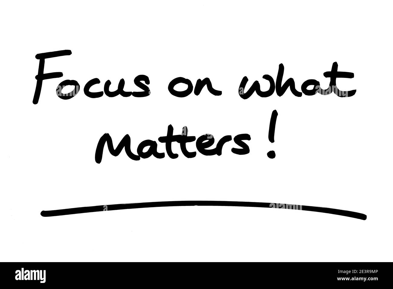 Focus on what matters! handwritten on a white background. Stock Photo
