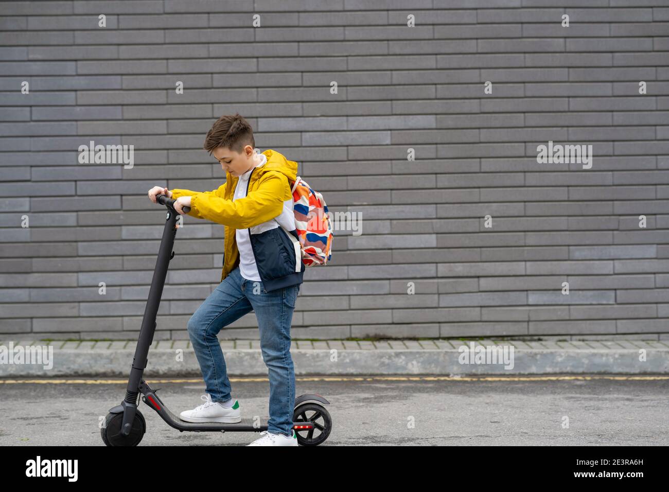 Modern teenager on electric scooter. Ecological transport concept Stock Photo