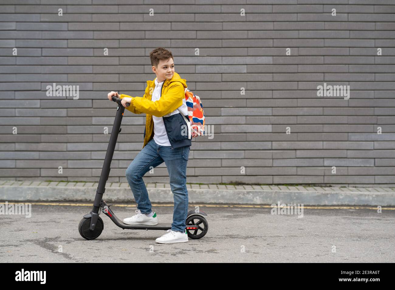 Modern teenager on electric scooter. Ecological transport concept Stock Photo