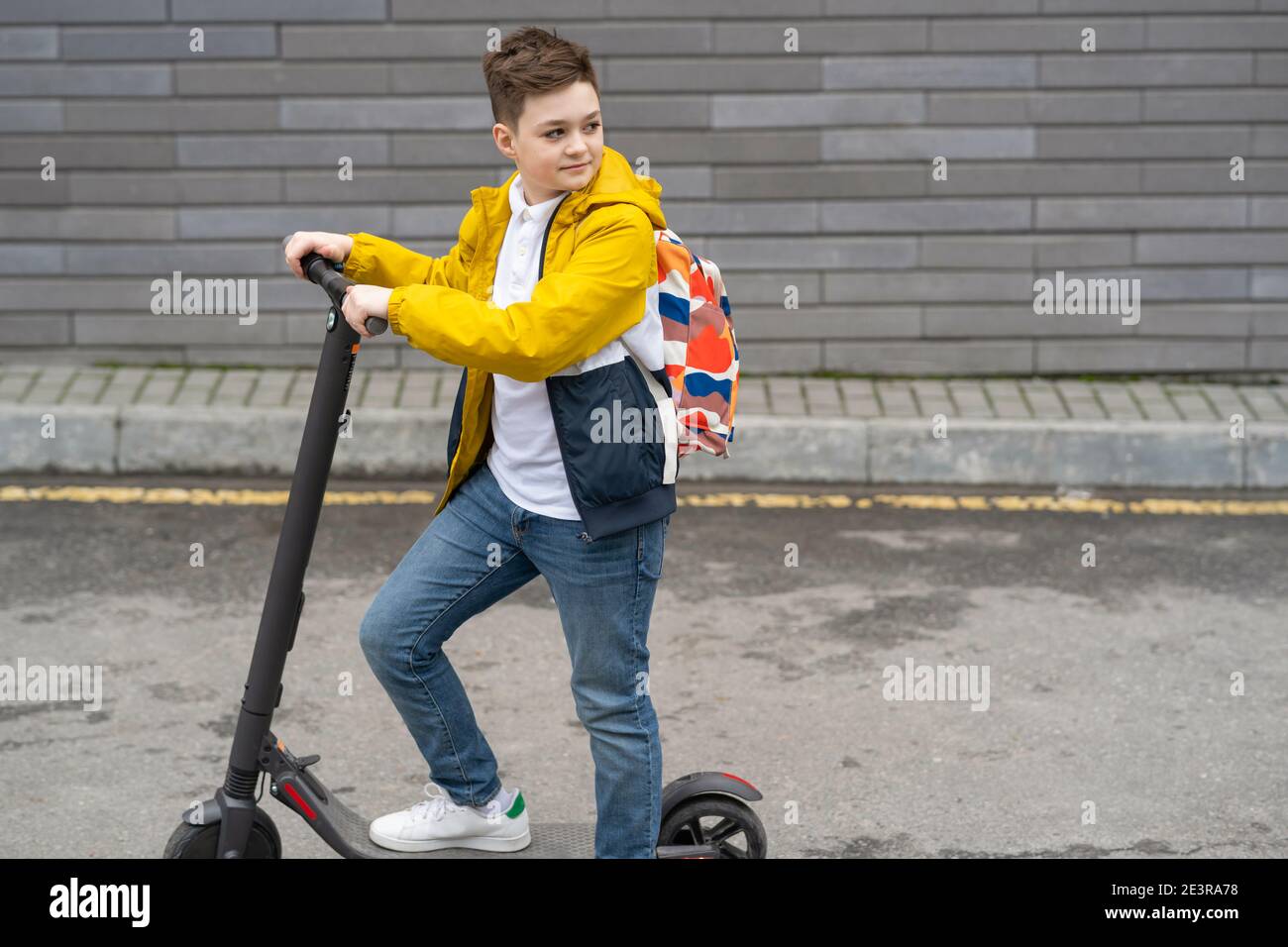 Modern teenager on electric scooter. Ecological transport concept Stock Photo