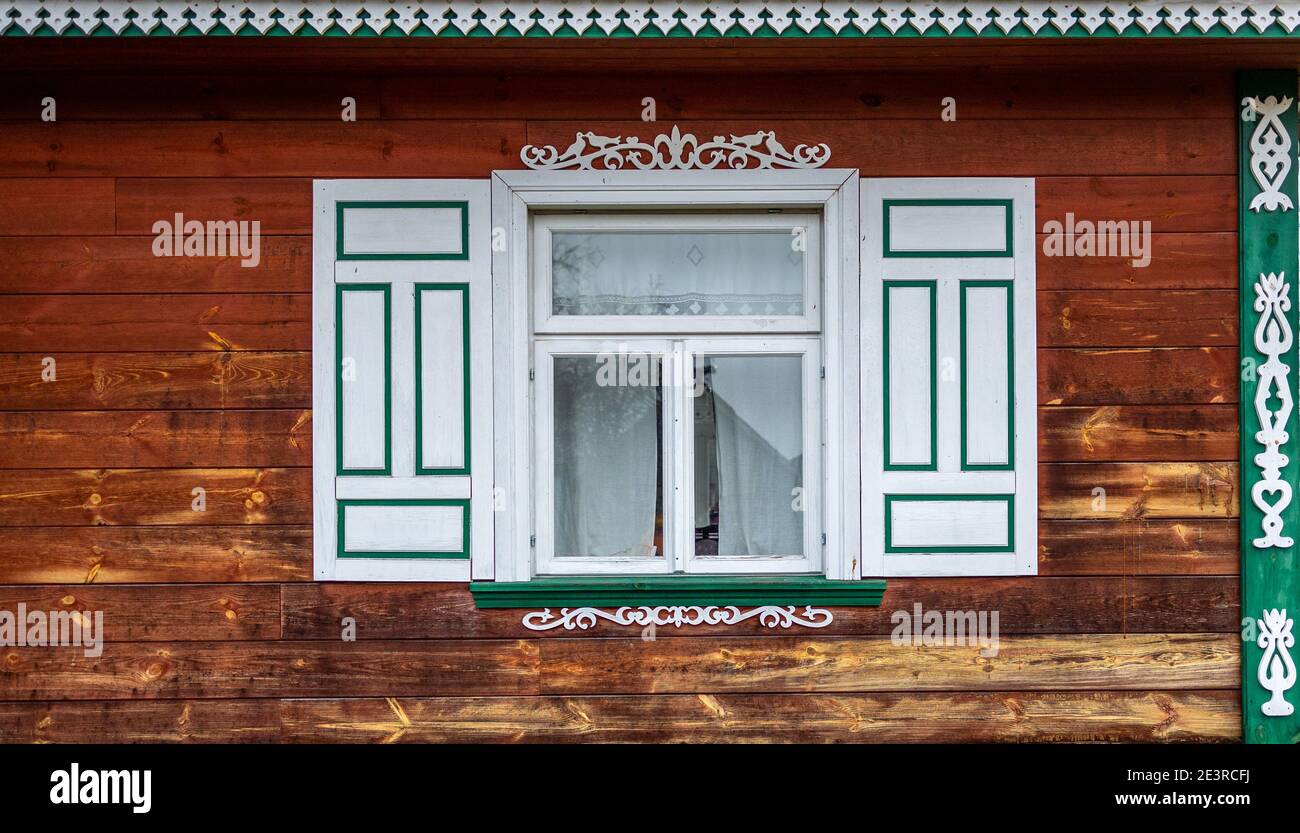 Window with decorative wooden shutters, Poland Stock Photo