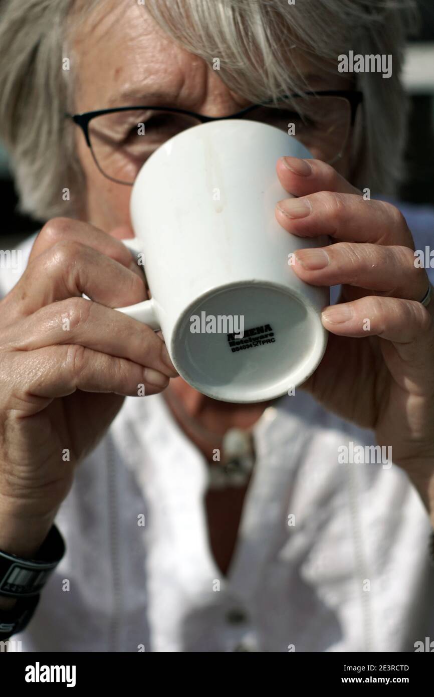 older mature women drinking mug of tea Stock Photo