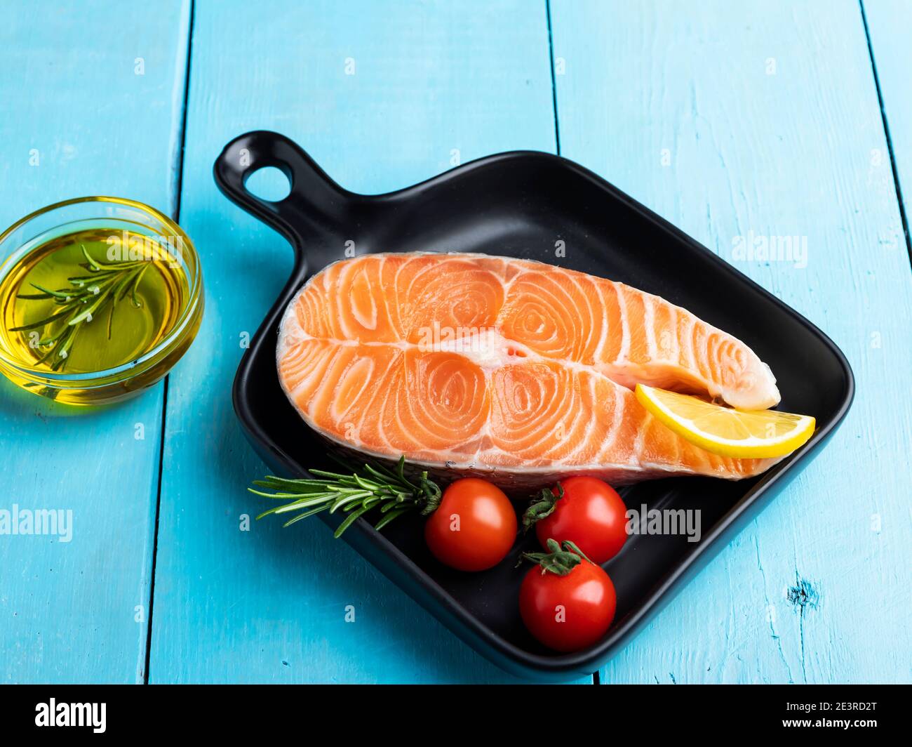 raw fresh steak fish trout, salmon and spices on a blue wooden background Stock Photo