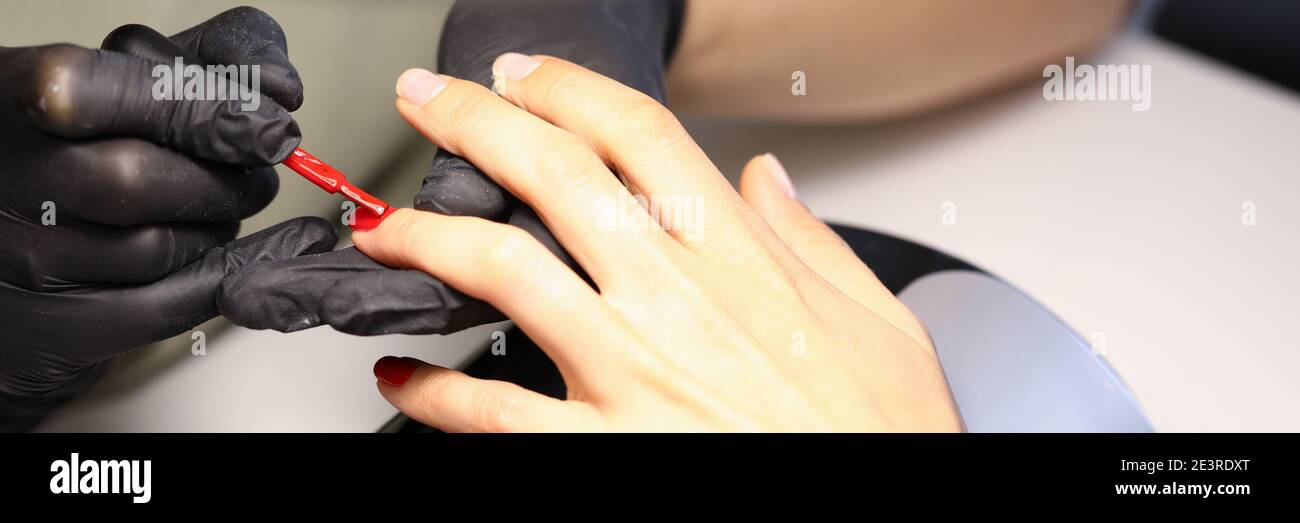 On female nails apply the perfect color of varnish Stock Photo Alamy