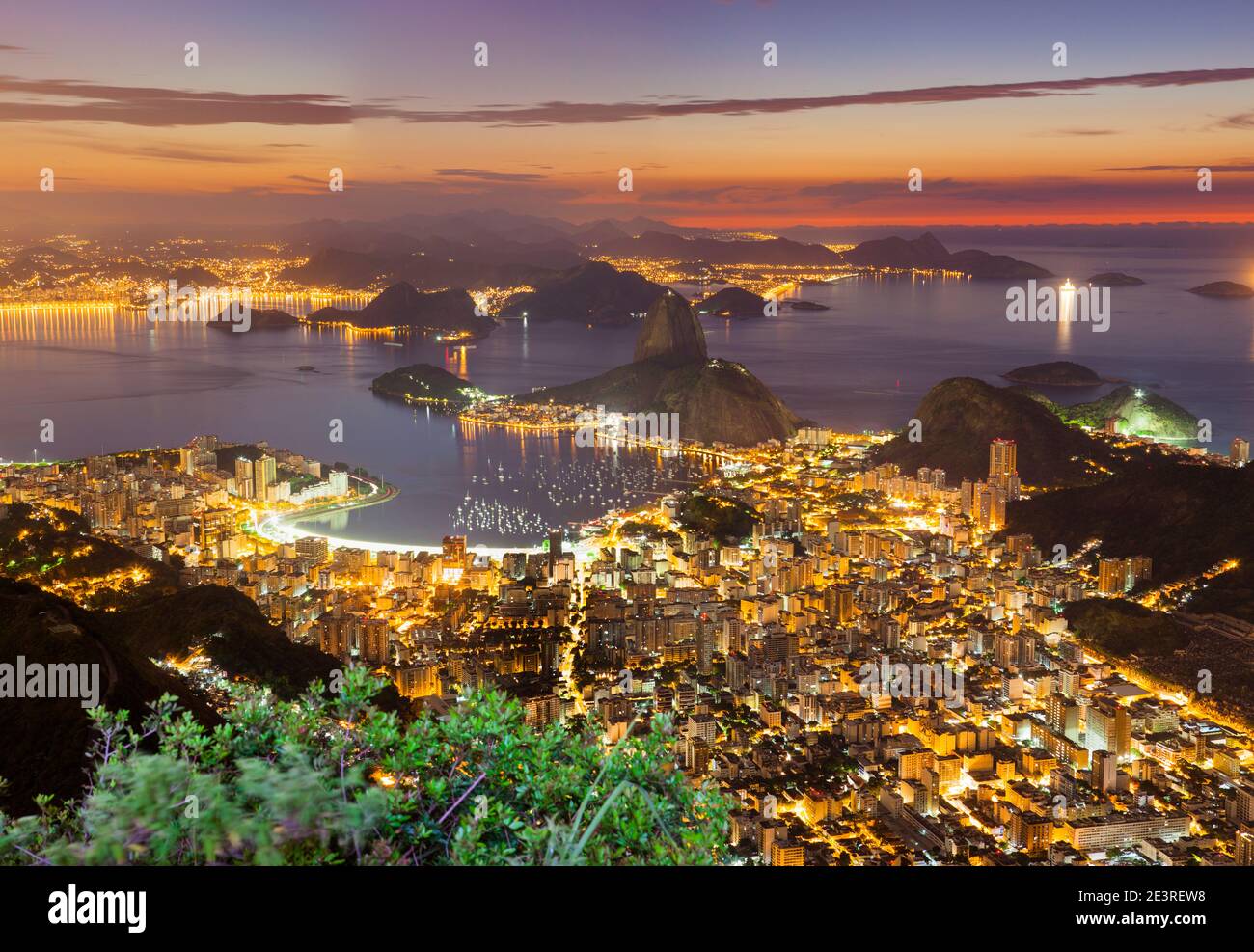 Rio de Janeiro cityscape, Brazil. Sugar Loaf, Botafogo beach and neighborhood seen from Corcovado mountain at sunrise. Stock Photo