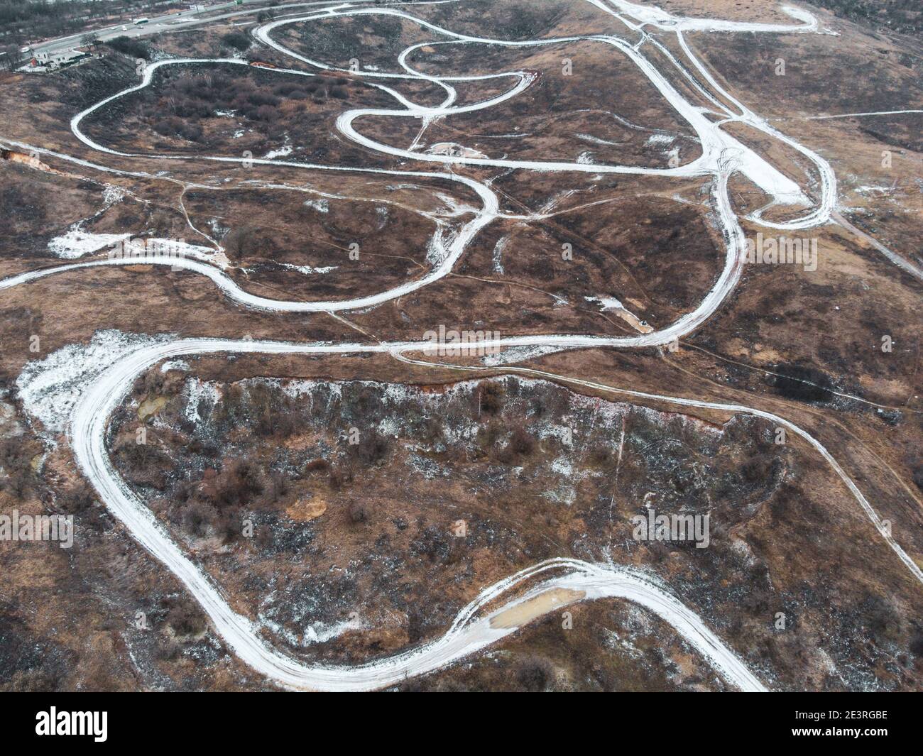 Dirt trail race track road aerial photo in winter with covered in snow lines. Outdoor sport racing terrain pattern Stock Photo