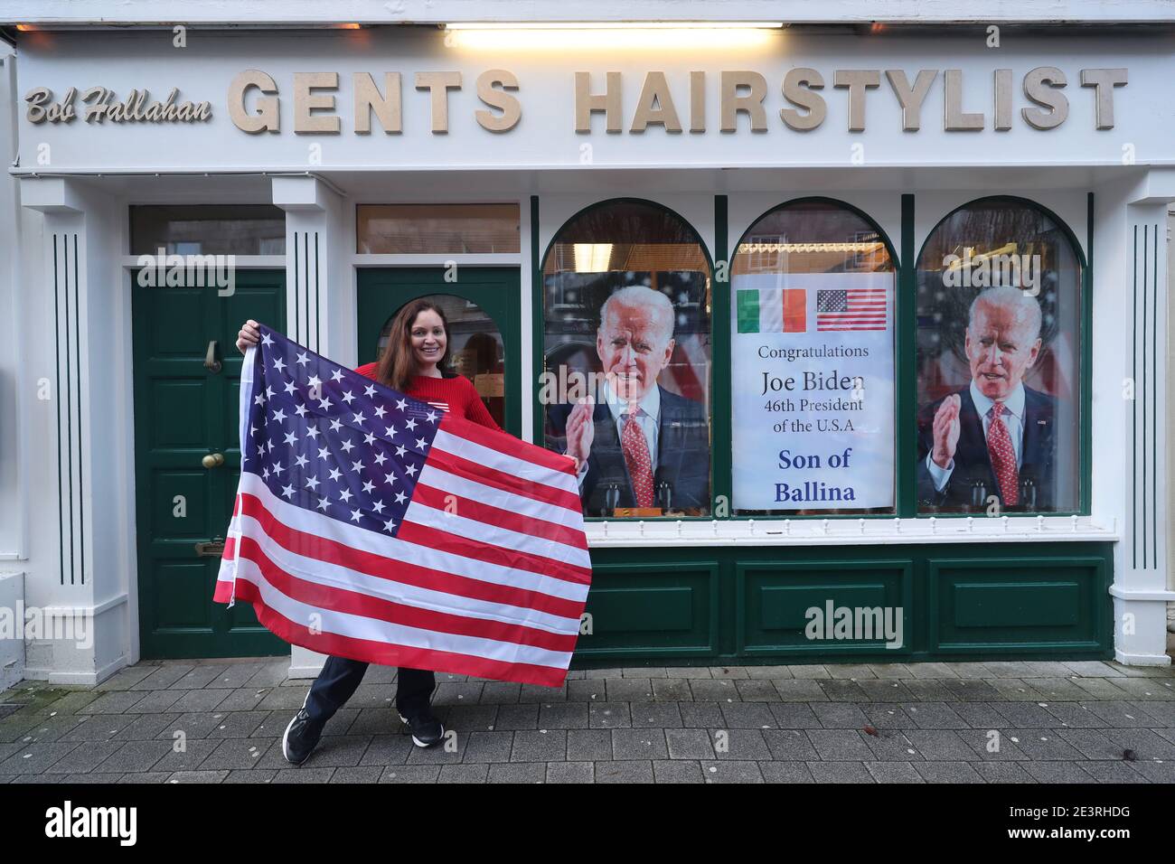 Doctor Catherine Hallahan prepares to hang an American flag inside her family's hairdressers in Ballina, Co Mayo to mark Mr. Biden's inauguration as the 46th President of the United States. President elect Biden has ancestral links to the area on the West coast of Ireland as well as on the Cooley Peninsula in Co. Louth, on the East coast. Stock Photo