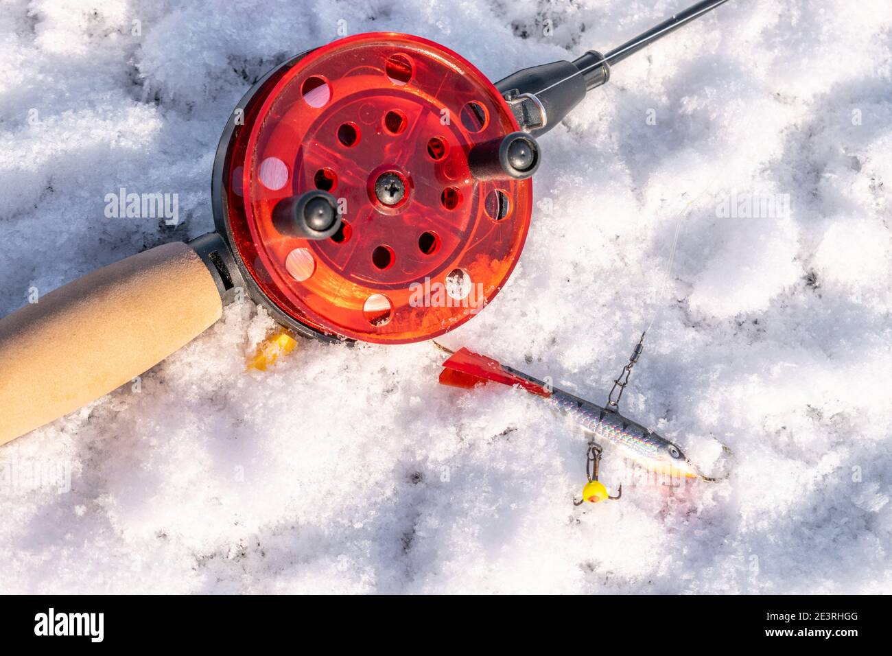 Winter fishing rod with a lure on ice closeup 7 Stock Photo