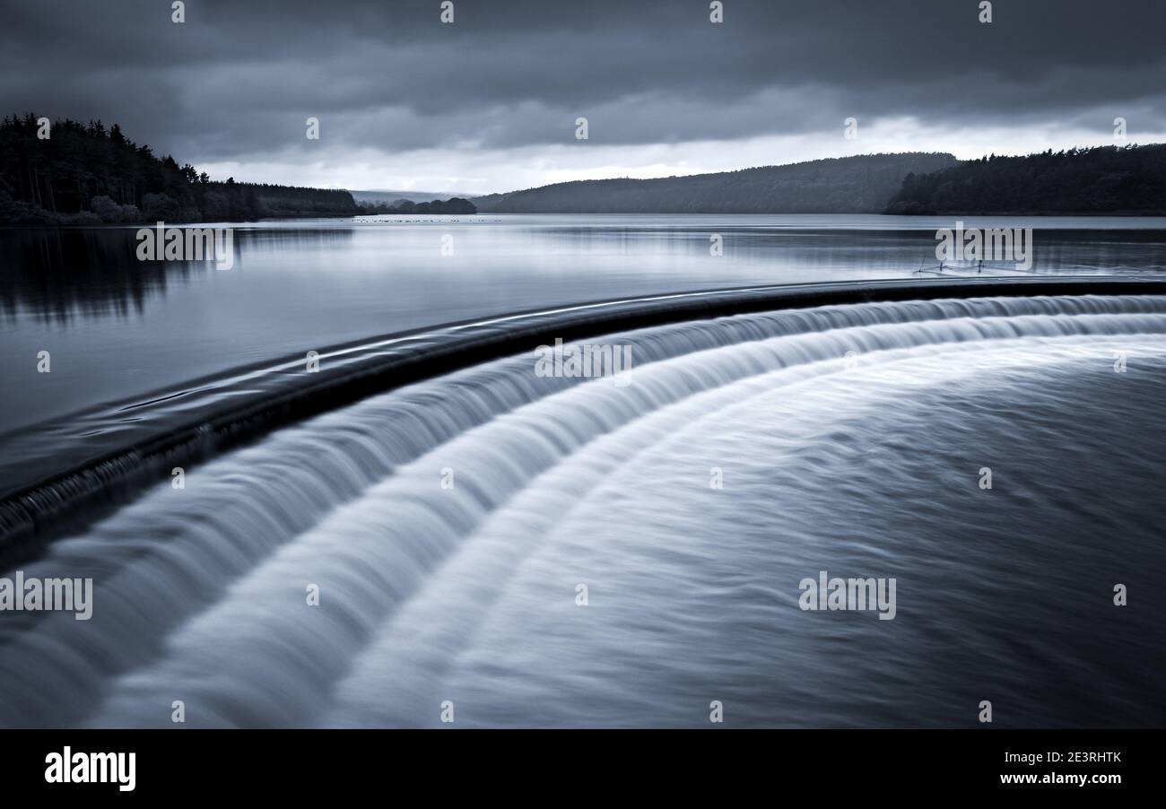 The overflow between Fewston and Swinsty Reservoirs in the Washburn Valley produces a beautiful ripple pattern as the water flows down the steps. Stock Photo