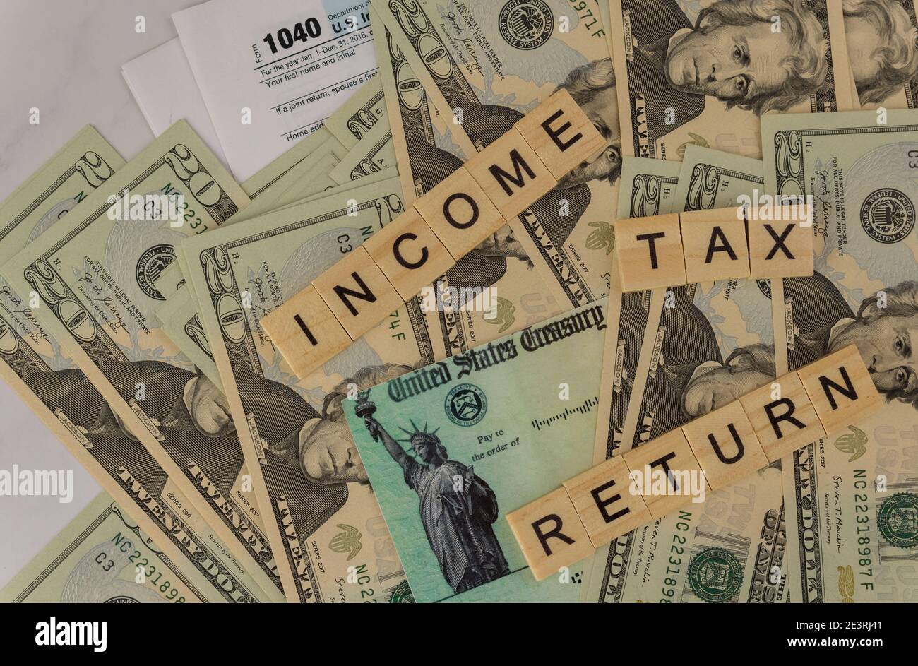 American blank tax forms 1040 estimated tax for individuals on dollar bill with income tax return in the accountant office on of Stimulus economic tax return check. Stock Photo