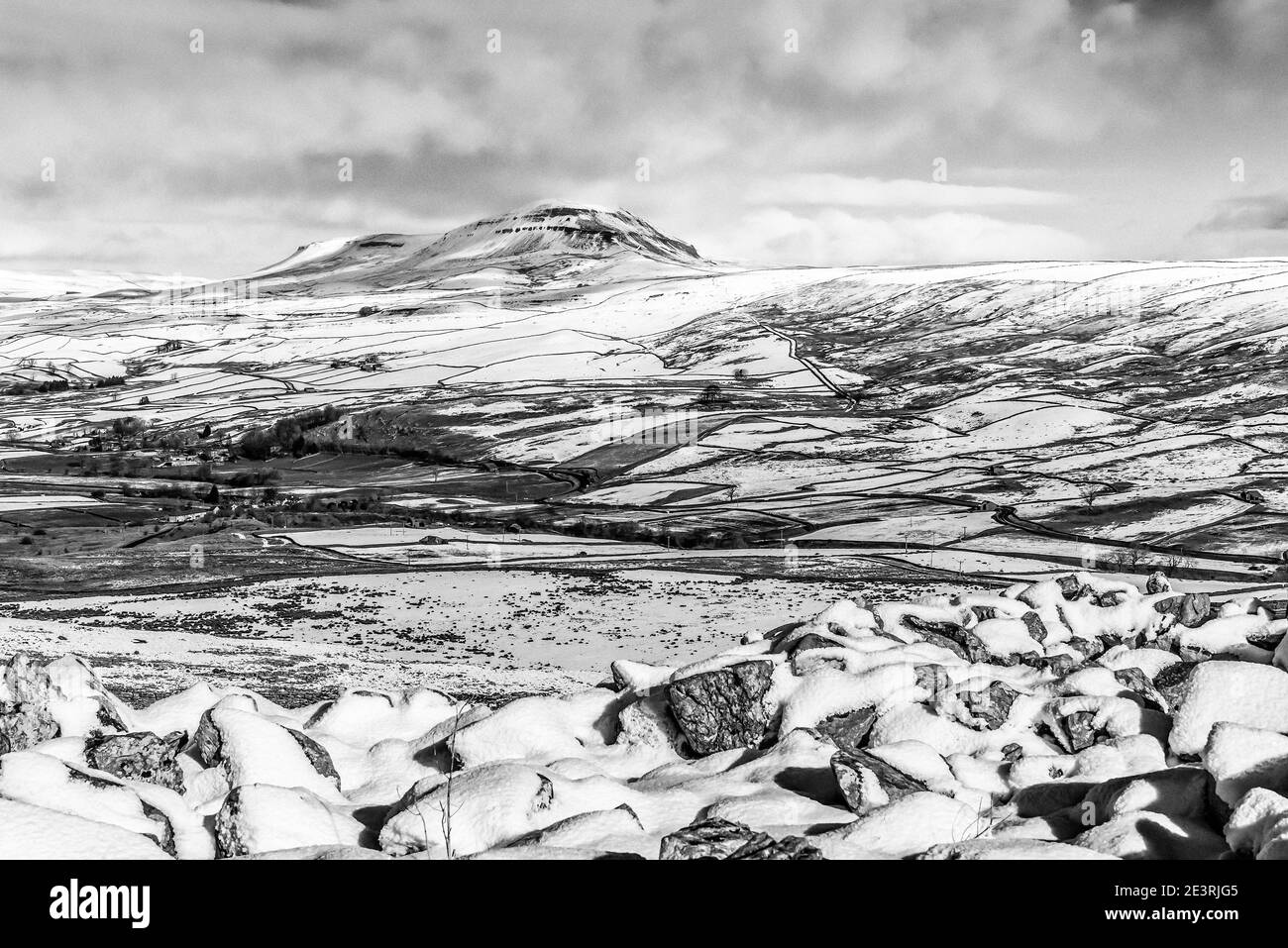 Fabulous winter scenery in monochrome of Penyghent one of the Yorkshire Dales Three Peaks as seen from Smearsett Scar Stock Photo