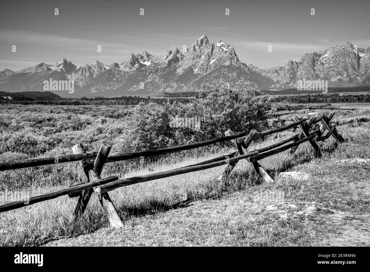 United States. The fabulous mountains of Grand Teton in monochrome in the Grand Teton National Park near Jackson, Wyoming in the United States. Seen here with the Buck and Rail fencing at Cunningham Cabin on the Antelope Flats that featured in the award winning western film SHANE that starred Alan Ladd. Stock Photo