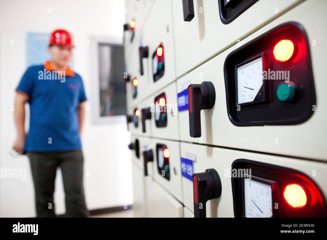Electrical worker walking through the electricity dial in the control