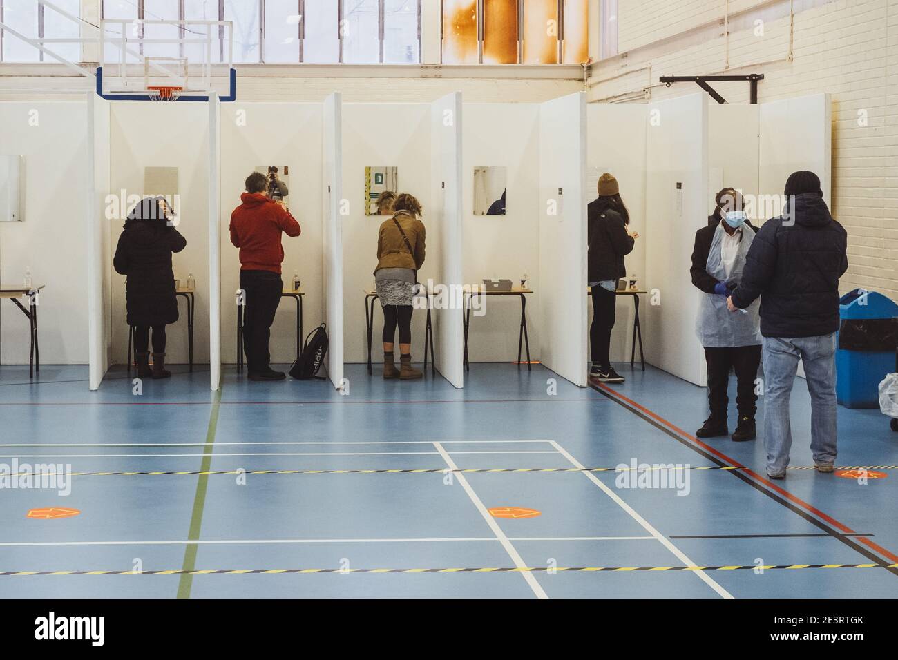 Camberwell, London, UK. 20th Jan, 2021. People line up in cubicles to ...