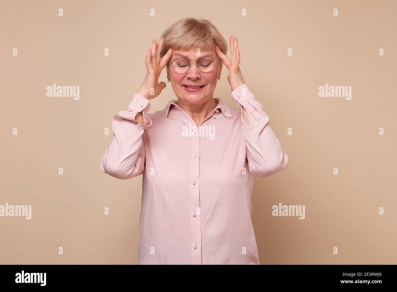 Woman fingers on temples hi-res stock photography and images - Alamy