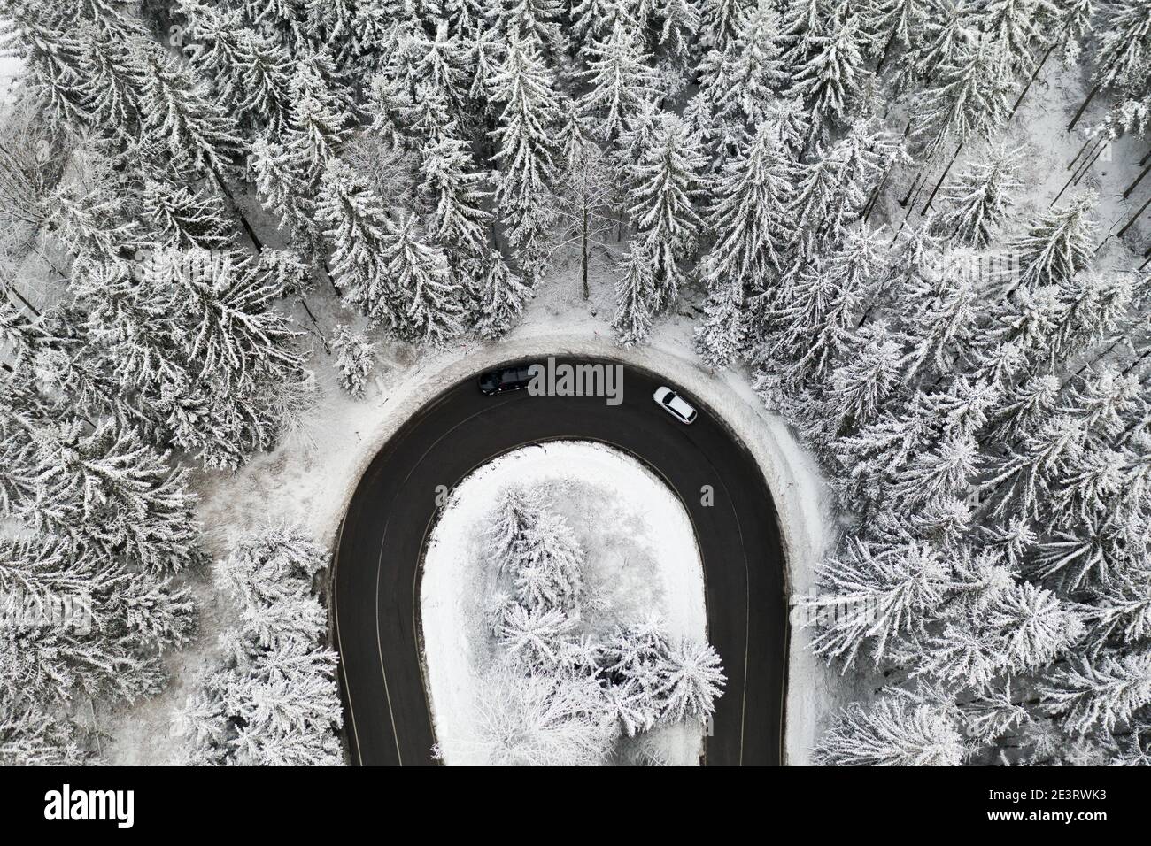 Aerial view on the road in the forest with one car at the winter ...