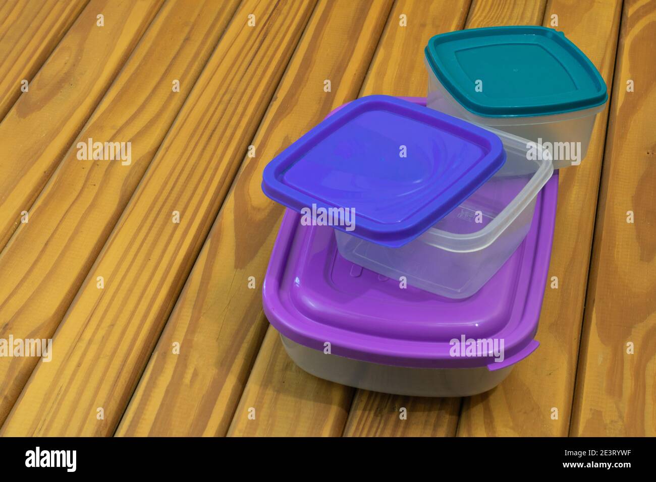 Hermetic plastic food containers on wooden base Stock Photo Alamy