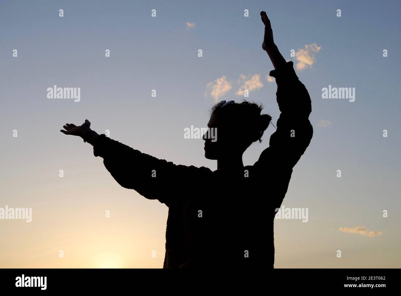 Woman silhouette standing open hands hi-res stock photography and ...