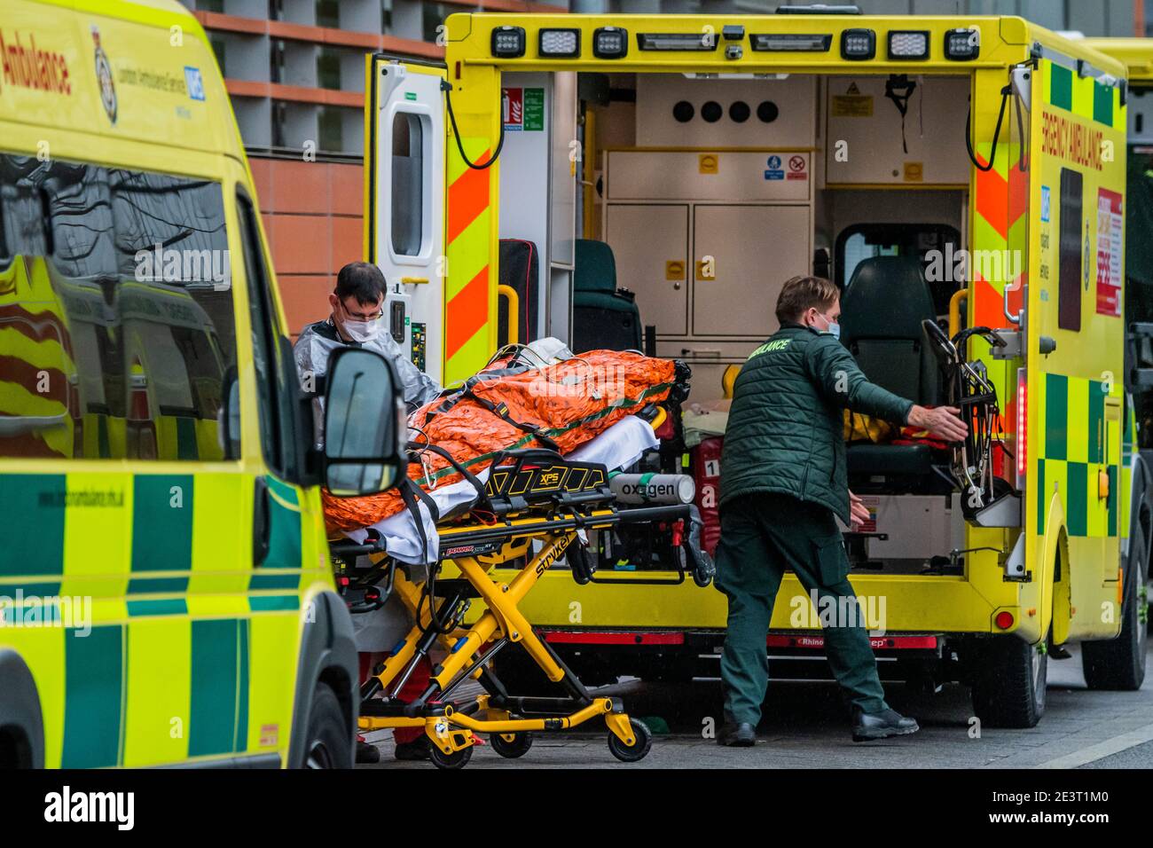 London, UK. 20th Jan, 2021. The Essex Air Ambulance crew brings in a patient - Ambulances arrive at the Accident and Emergency Department to drop off patients at the Royal London Hospital in Whitechapel. London is in national Lockdown 3 and pressure on beds in the NHS remains high. Credit: Guy Bell/Alamy Live News Stock Photo