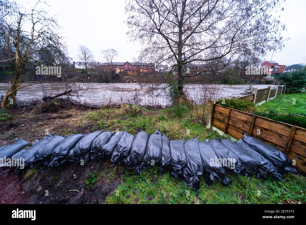 Prestolee, Bolton, England, UK. 20th Jan 2021. Consistent rainfall from Storm Christoph over the last 24 hours has led to the level of the River Irwell rising significantly. Sandbags are laid out on the banks of the Irwell at Riverside drive, a very flood prone part of the village. A flood warning has now been issued for the River Irwell at Prestolee and Ringley bridges. The village of Prestolee experienced flooding in 2015 and 2020 when the Irwell burst its banks. Credit: Callum Fraser/Alamy Live News Stock Photo