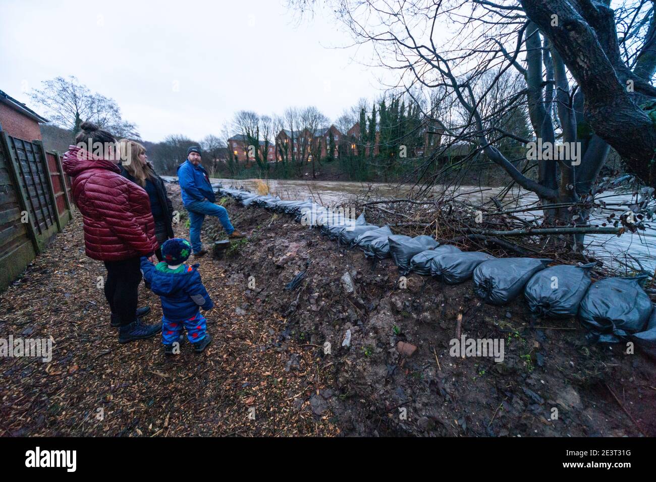 Prestolee, Bolton, England, UK. 20th Jan 2021. Consistent rainfall from Storm Christoph over the last 24 hours has led to the level of the River Irwell rising significantly. Sandbags are laid out on the banks of the Irwell at Riverside drive, a very flood prone part of the village. A flood warning has now been issued for the River Irwell at Prestolee and Ringley bridges. The village of Prestolee experienced flooding in 2015 and 2020 when the Irwell burst its banks. Credit: Callum Fraser/Alamy Live News Stock Photo