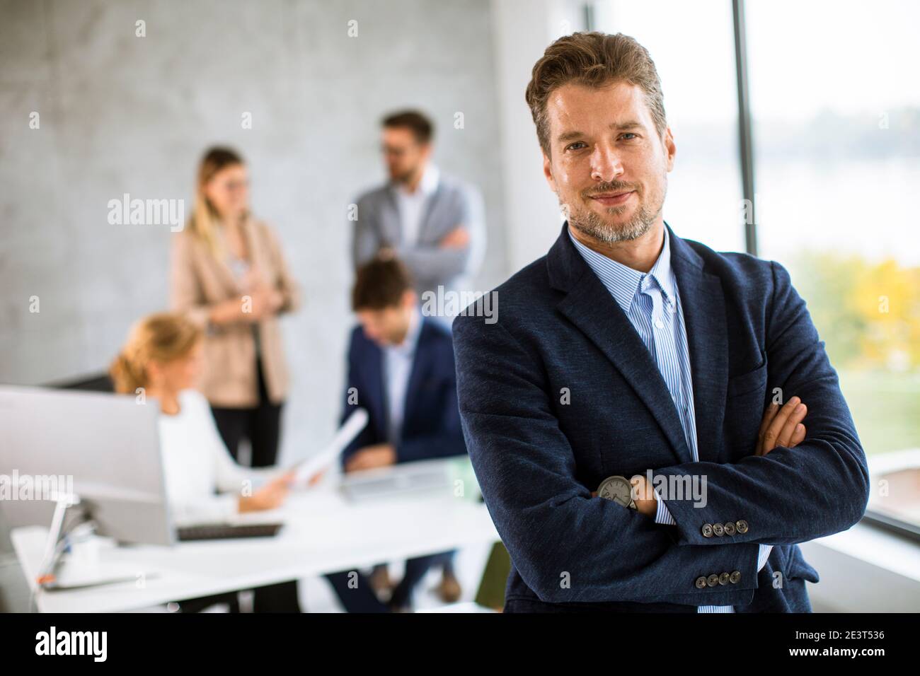 Handsome young business man standing confident in the office in front ...