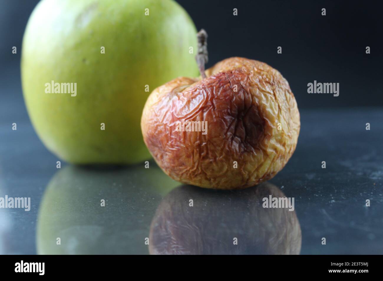 apple ugly spoiled and beautiful good on a black background copyspace. Stock Photo