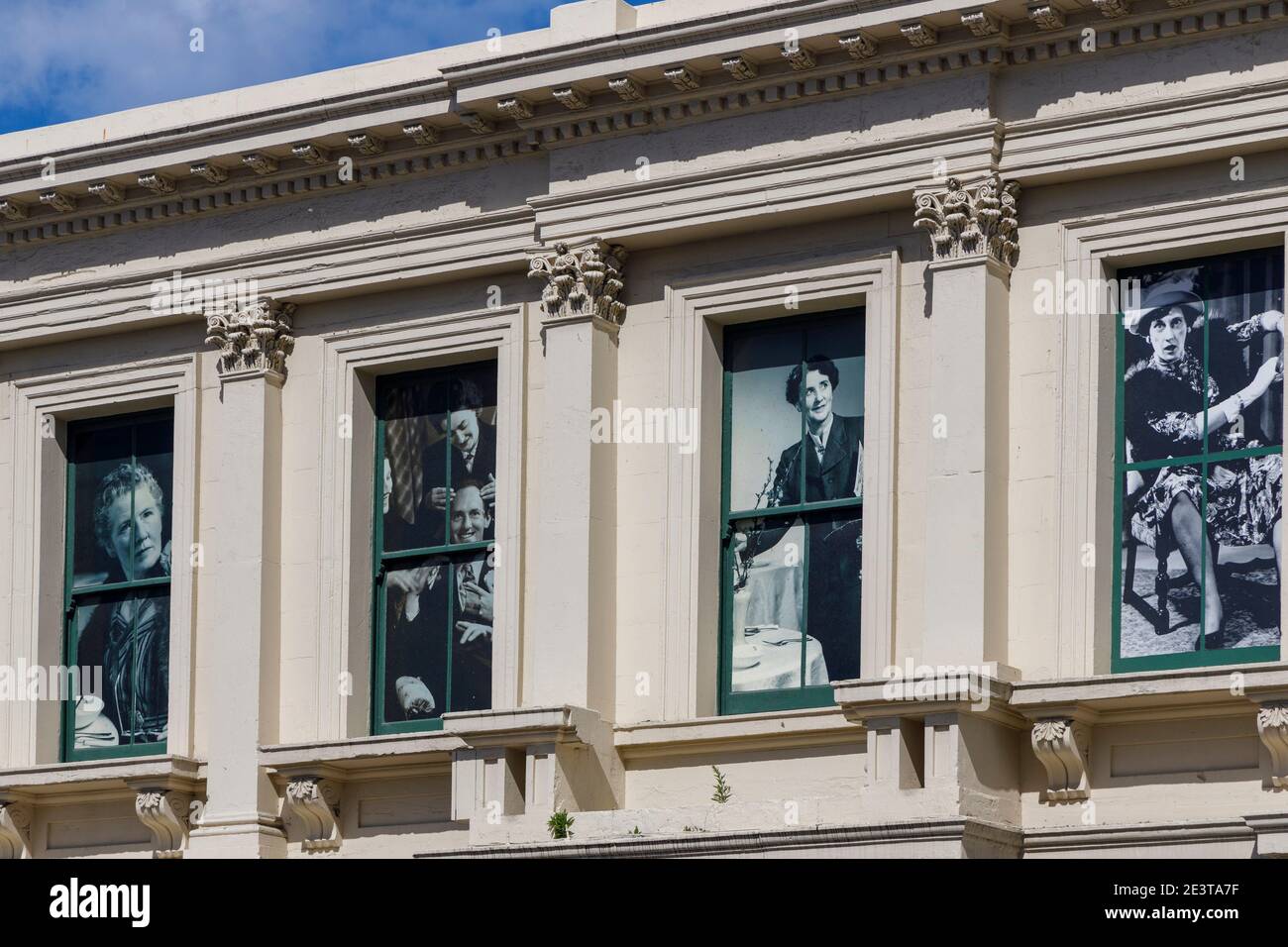 The circa 1870 Oamaru Repertory Society building, recently renovated, Oamaru, South Island, New Zealand. Historic theatrical figures in upper windows. Stock Photo