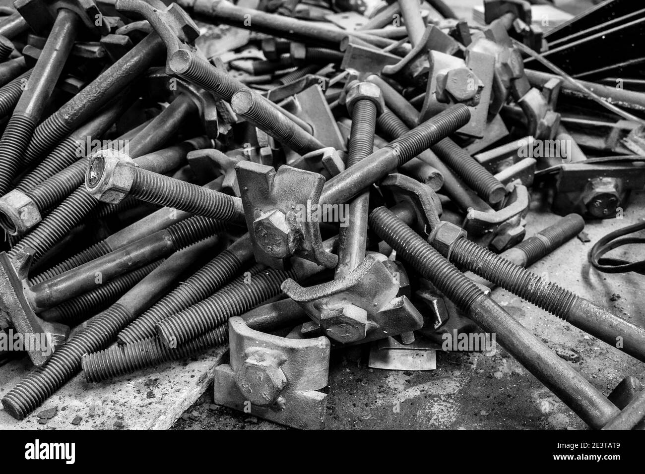 A pile of nuts and long bolts in the workshop of the Oamaru Steam and Rail Restoration Society, Oamaru, New Zealand. Stock Photo