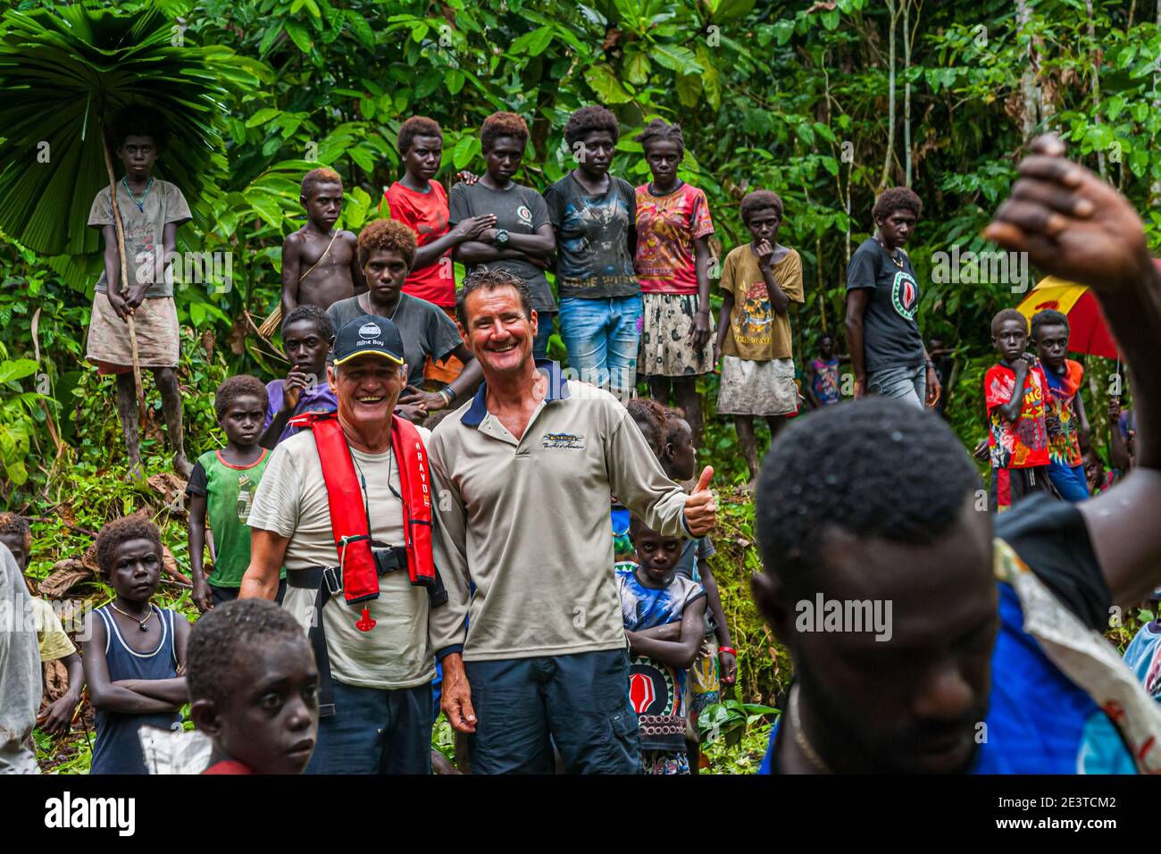 Native people with foreign guests in the bougainville jungle Stock Photo