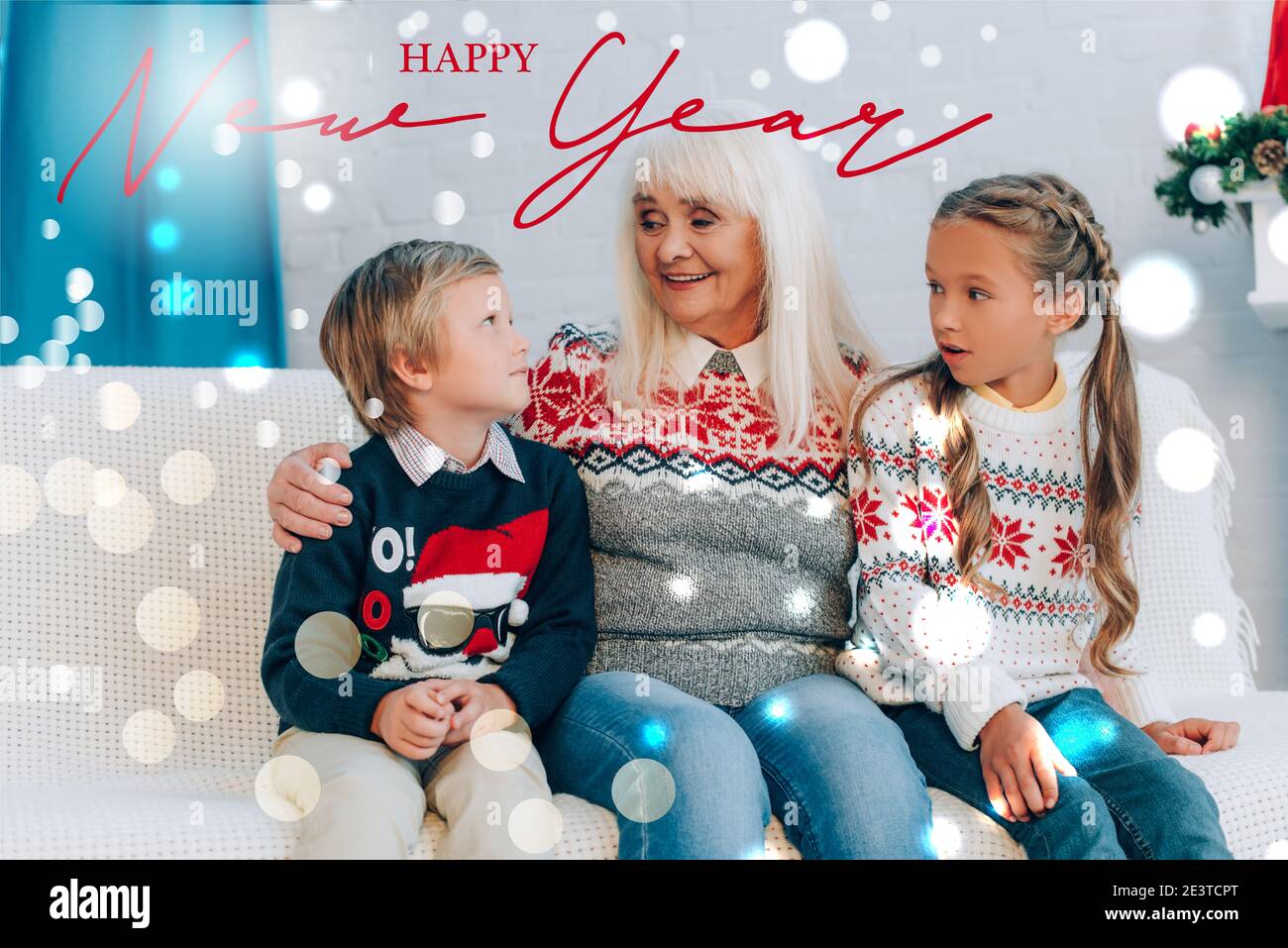 smiling senior woman talking to grandchildren while sitting on sofa together, happy new year illustration Stock Photo
