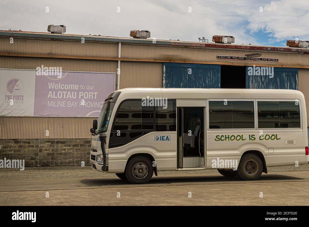 School bus with the label 'School is cool' in the port of Alotau, Papua New Guinea Stock Photo