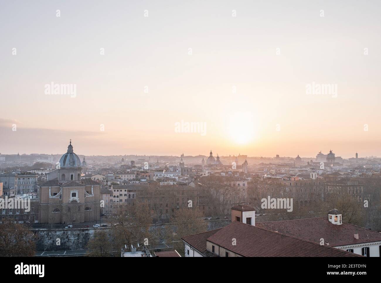 View down onto central Rome, Italy, from Trastevere, across the River Tiber, at sunrise. Stock Photo