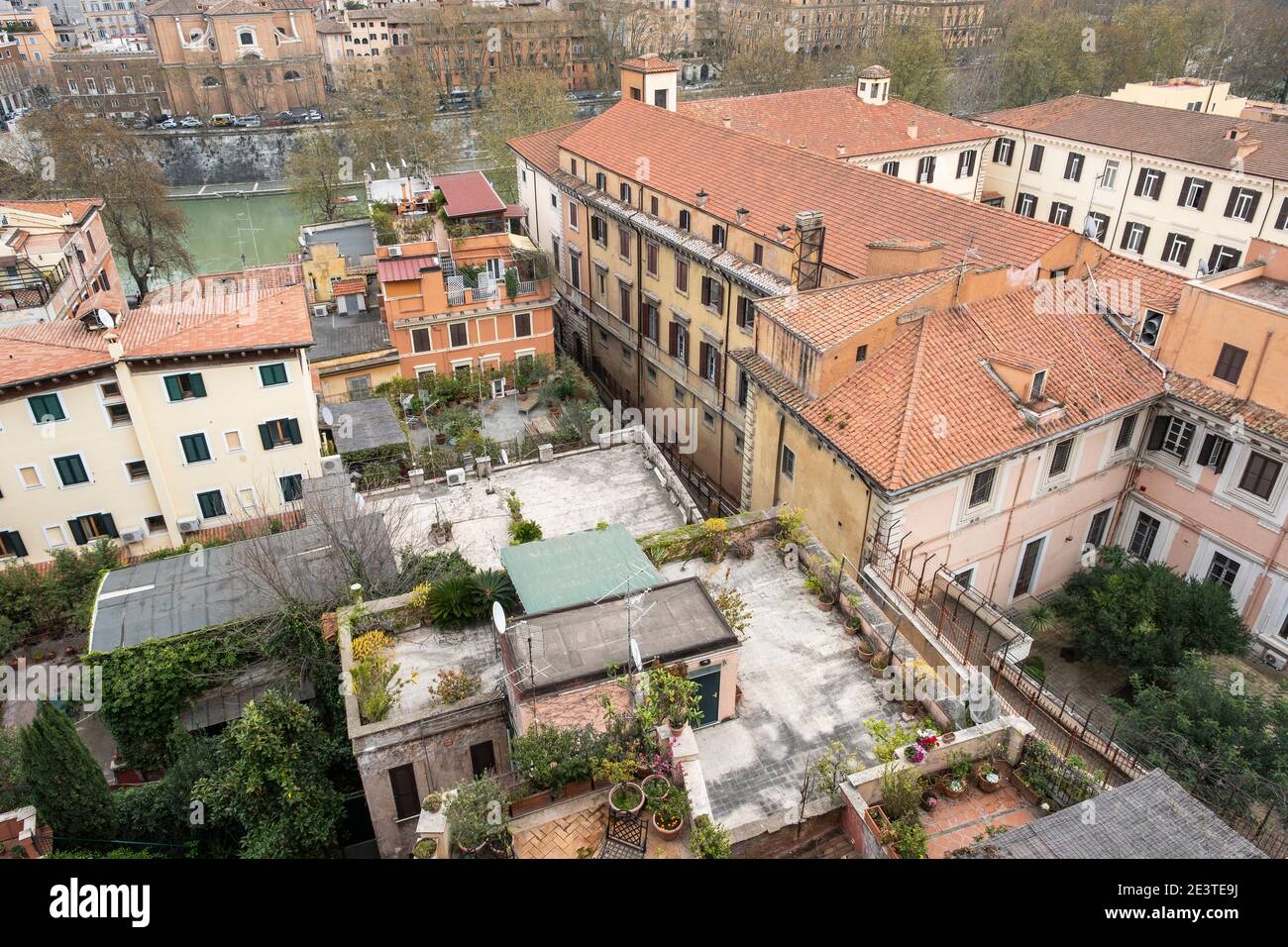 Aerial view looking down onto rooftops and roof terraces of buildings on the banks of the River Tiber, Trastevere, Rome, Italy Stock Photo