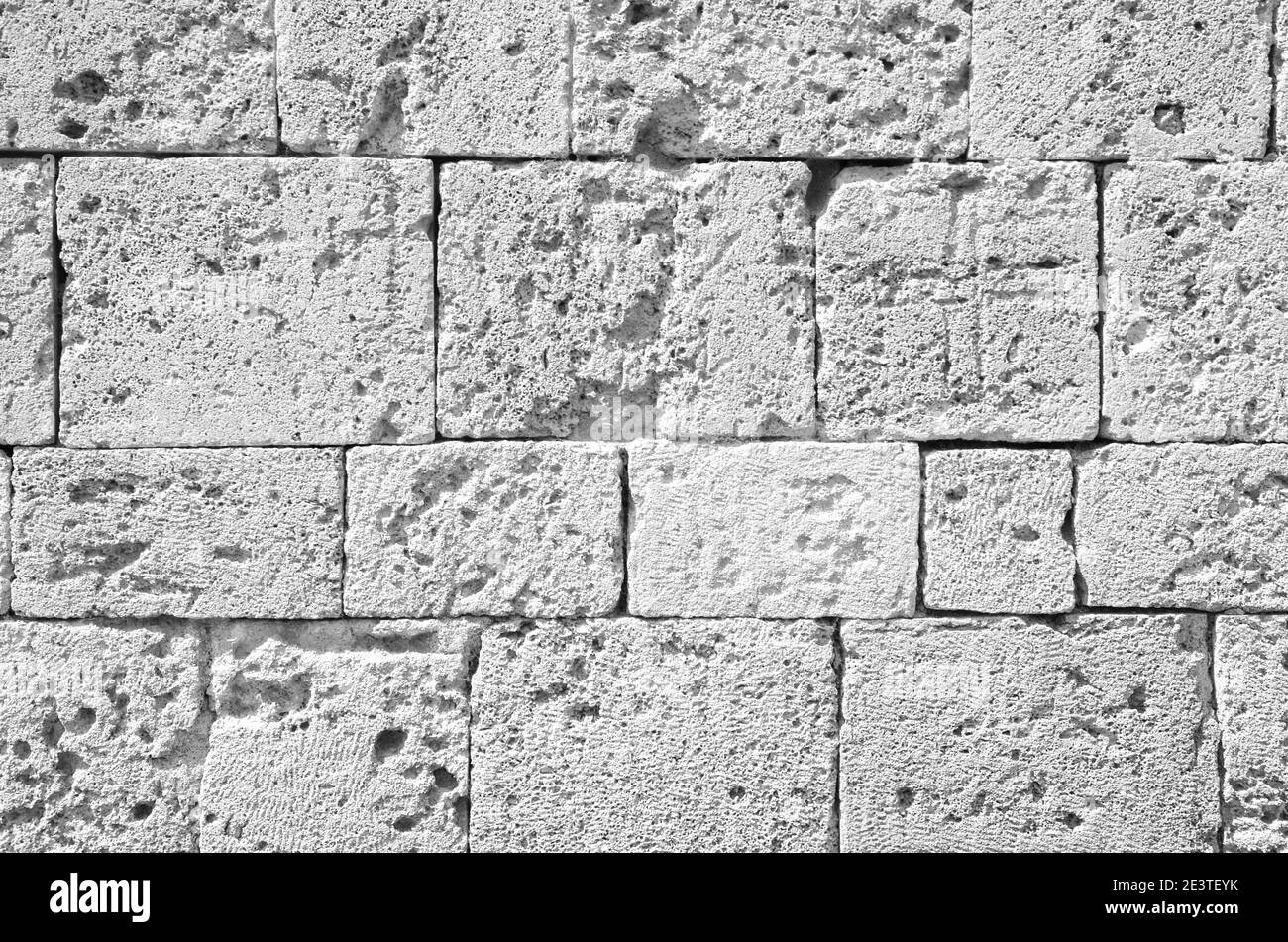 Background of ancient brick wall. Texture of old amphitheater stone for design. Monochrome. High quality photo Stock Photo