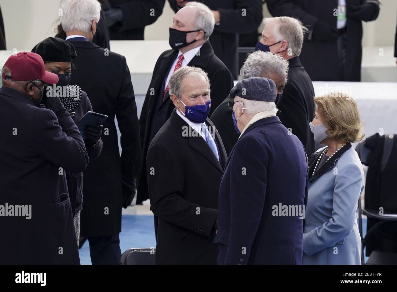 Former U.S. President George W. Bush, center, wears a protective mask  during the 59th presidential inauguration in Washington, DC, U.S., on  Wednesday, Jan. 20, 2021. Biden will propose a broad immigration overhaul