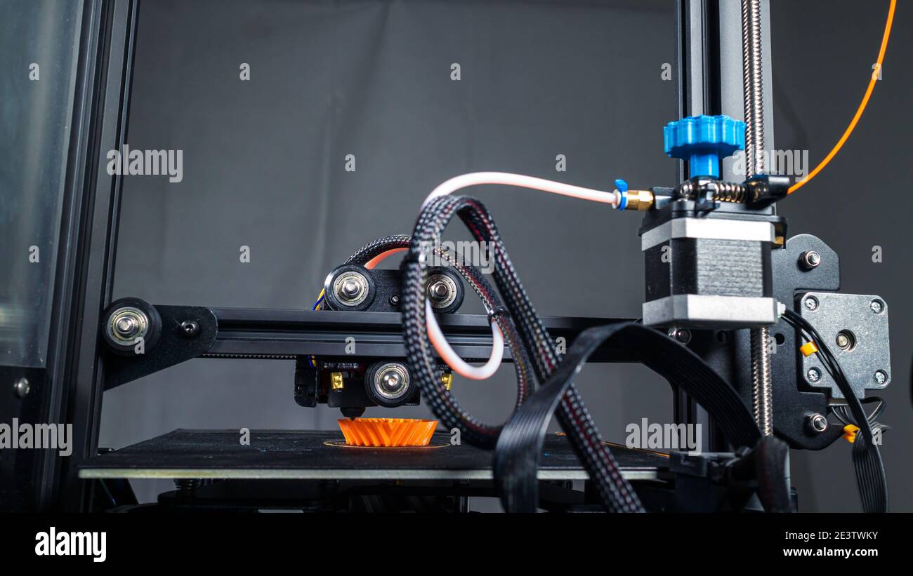 3D plastic printer during work in a factory three dimensional printing. Close-up detail. Stock Photo