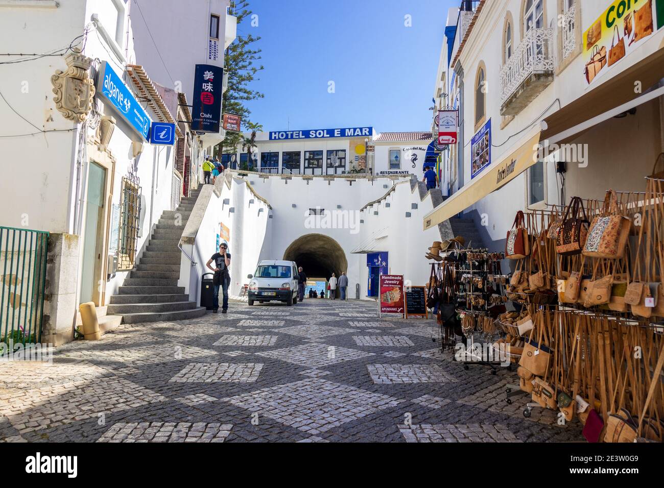 Tourists Walk On Rua 5 de Outubro Albufeira Old Town During Winter In February, The Tunnel Leads To The Beach In Albufiera The Algarve Portugal Stock Photo