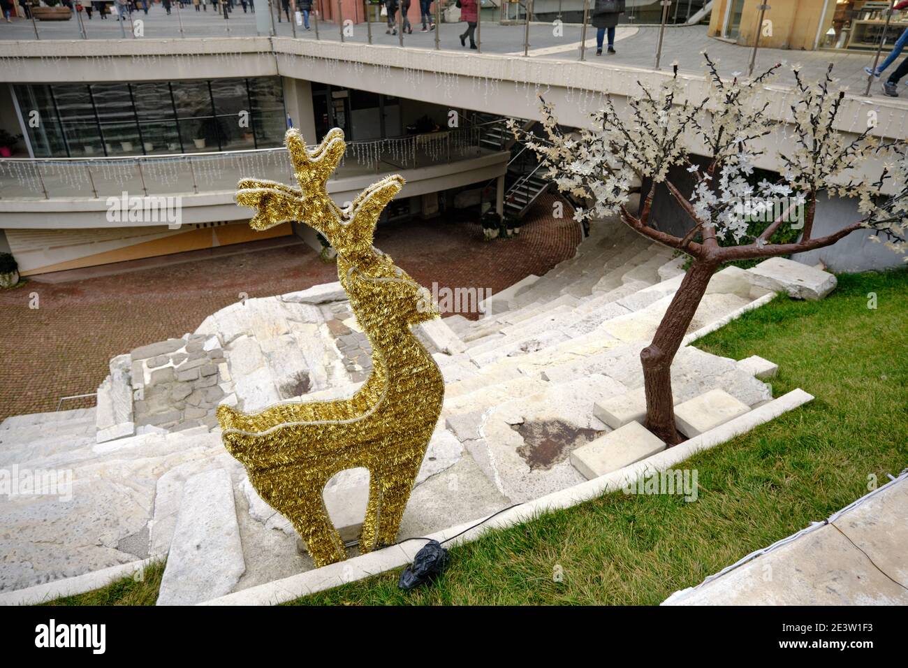 Plovdiv Roman Stadium and golden yellow colored deer body and tree for ...