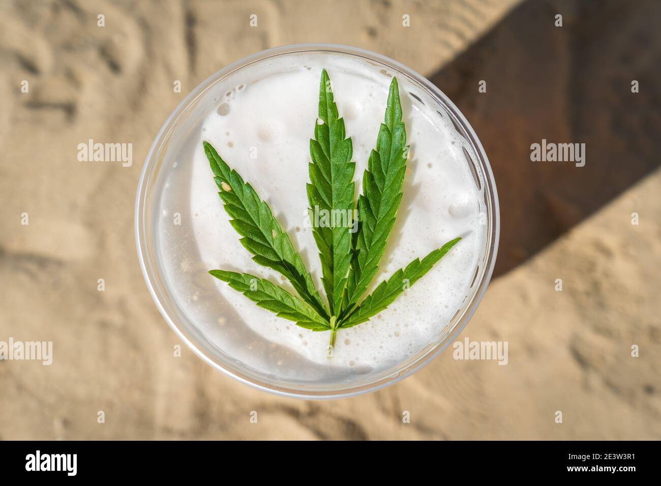 Cannabis beer with herbal leaf of marijuana on the foam surface Stock Photo