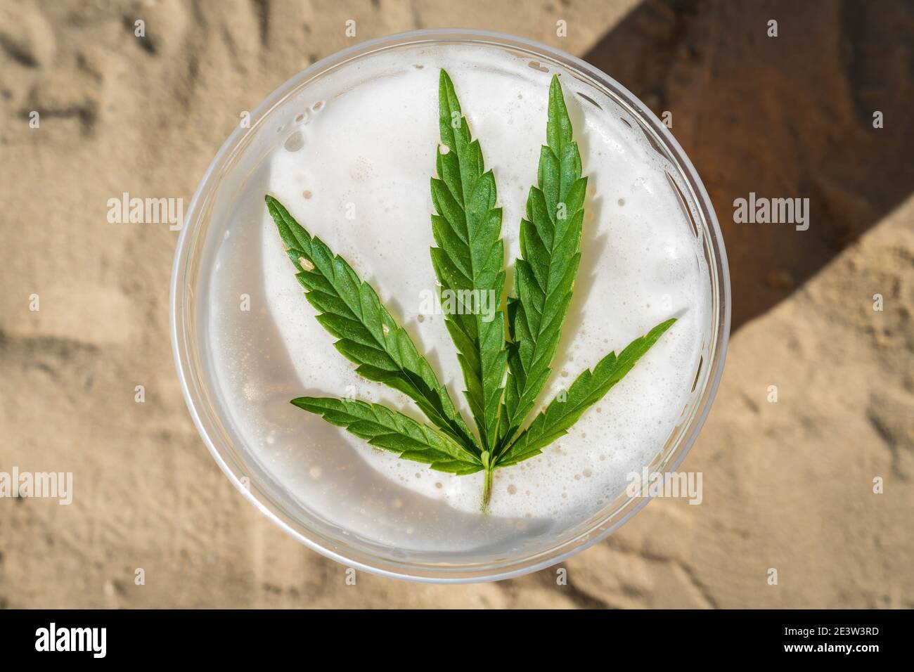 Cannabis beer with herbal leaf of marijuana on the foam surface Stock Photo