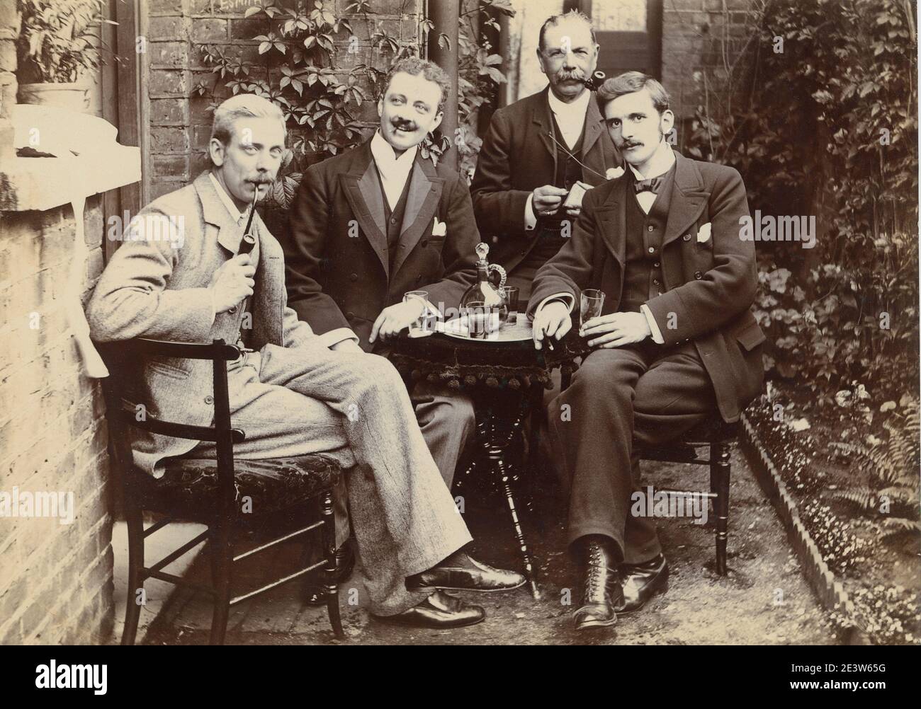 1890s Victorian portrait of an unknown fashionably dressed older man seated in a garden. One of a sequence of ten photographs of friends and family in the same setting. Stock Photo