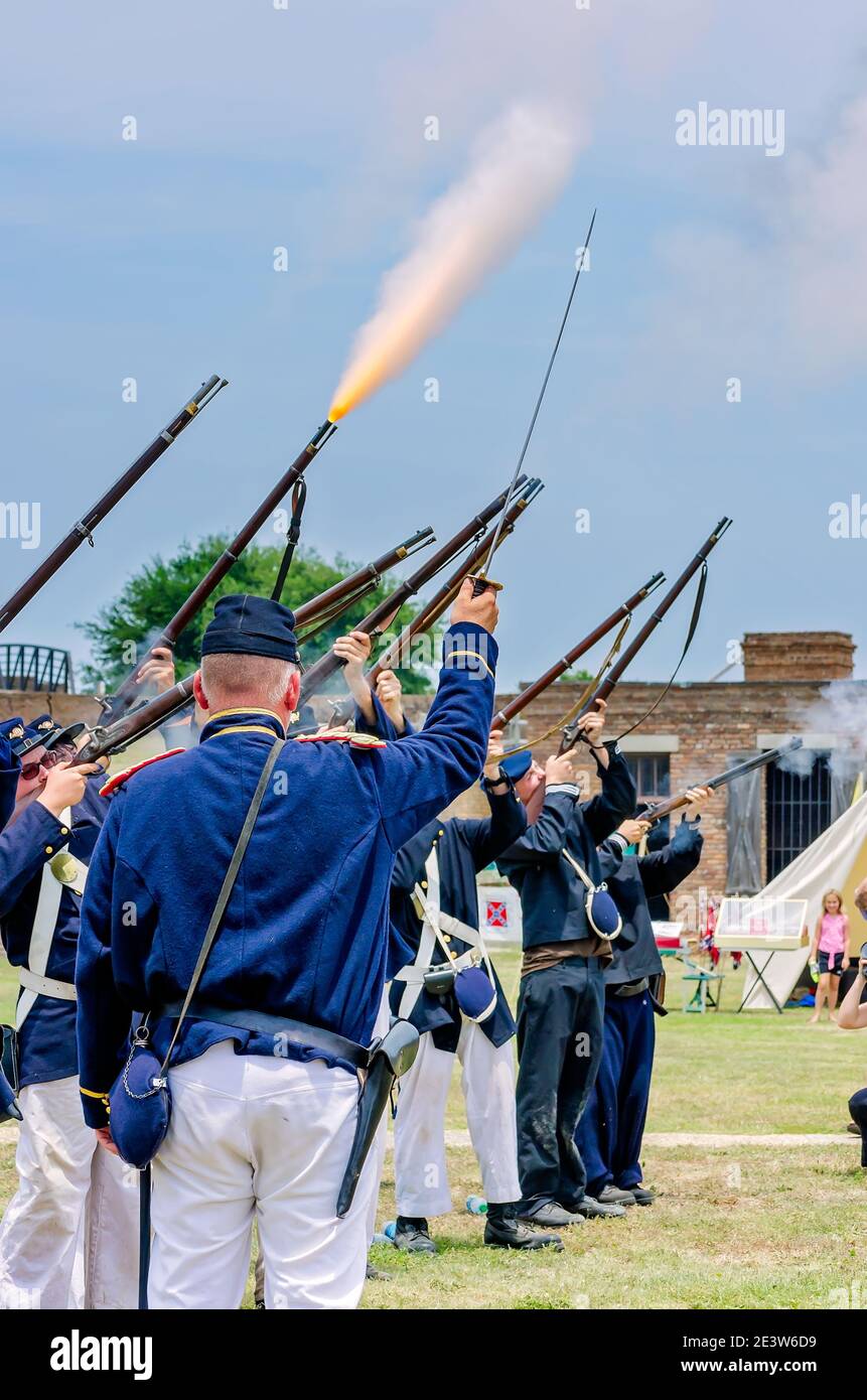 Civil War reenactors from the Union Army fire rifles at Fort Gaines during a reenactment of the 150th Battle of Mobile Bay in Dauphin Island, Alabama. Stock Photo