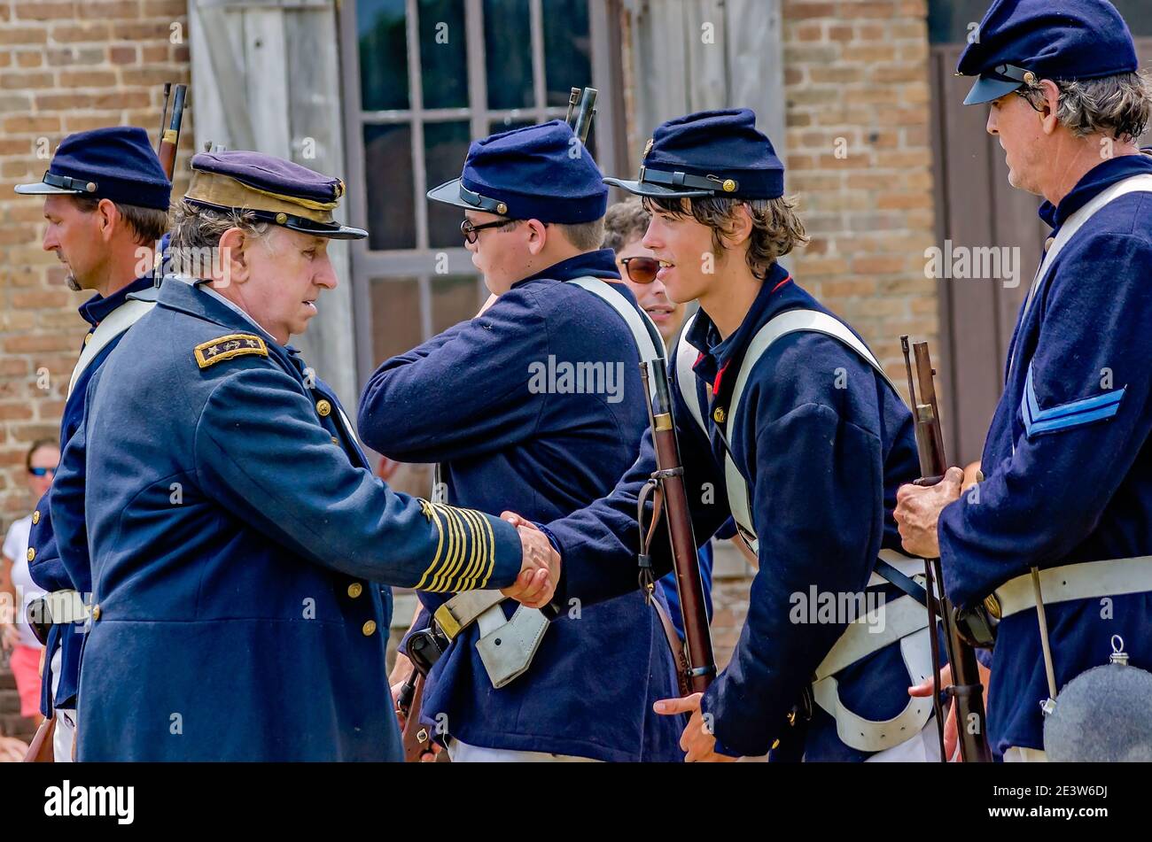 Civil War reenactors from the Union Army shake hands at Fort Gaines